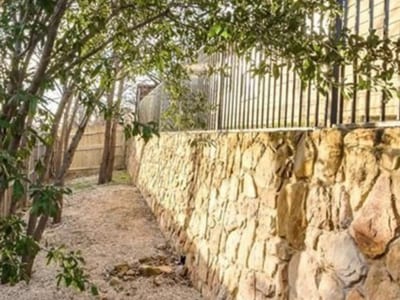 Stone veneer retaining wall